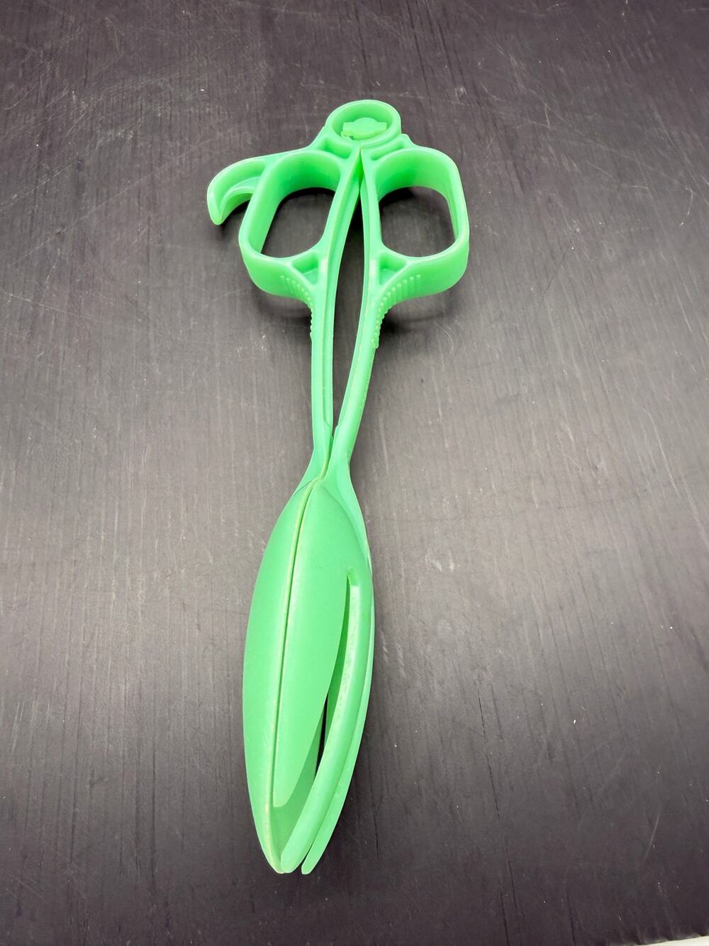 Vintage 1950s Tupperware scissor-style salad tongs in a bright green color